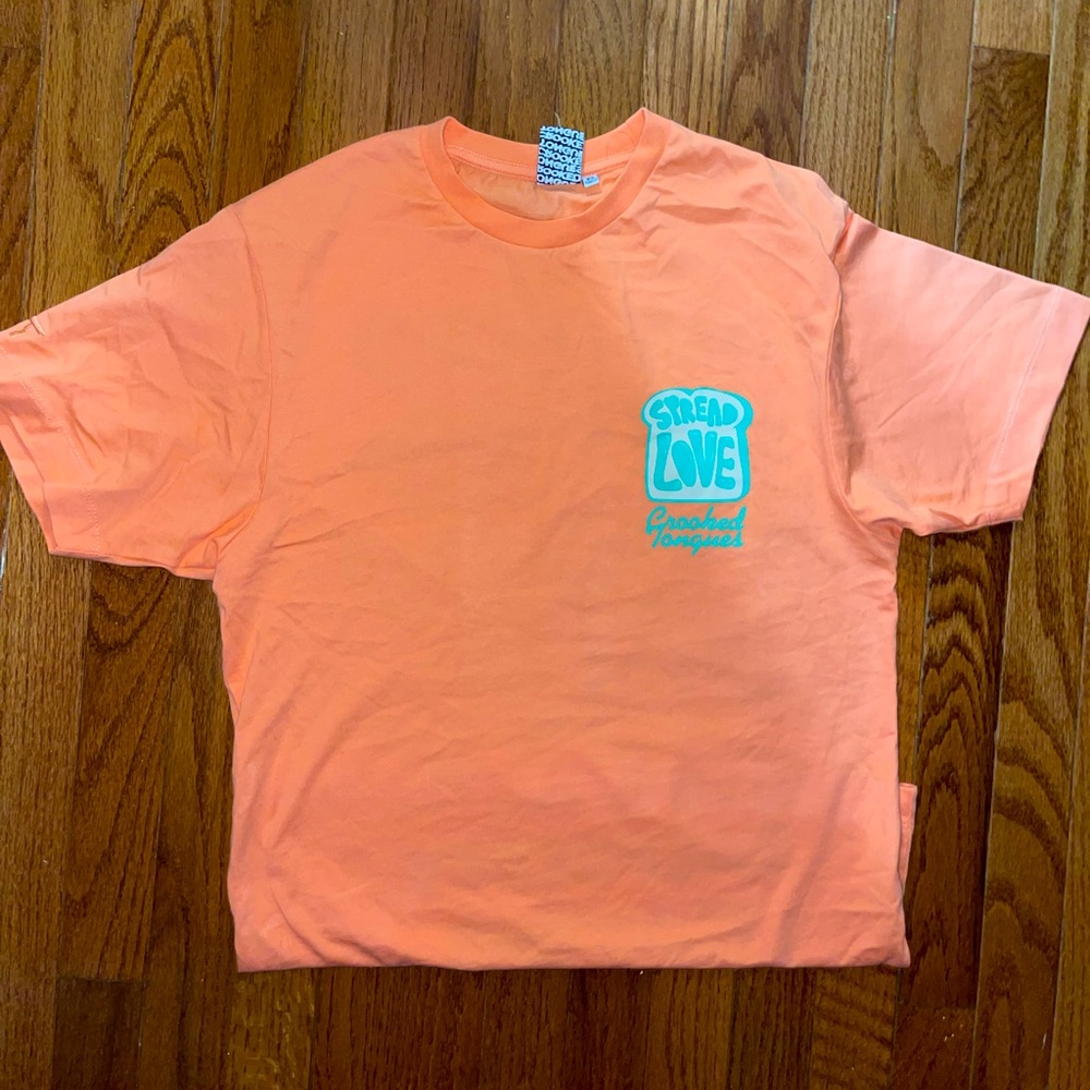 Oversized small women’s shirt. Baby orange graphic. Brand- Crooked Tongue.